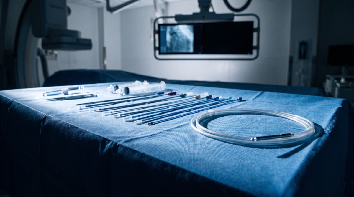 Catheters and guidewires laid out on a sterile catheter laboratory table (illustrative image)