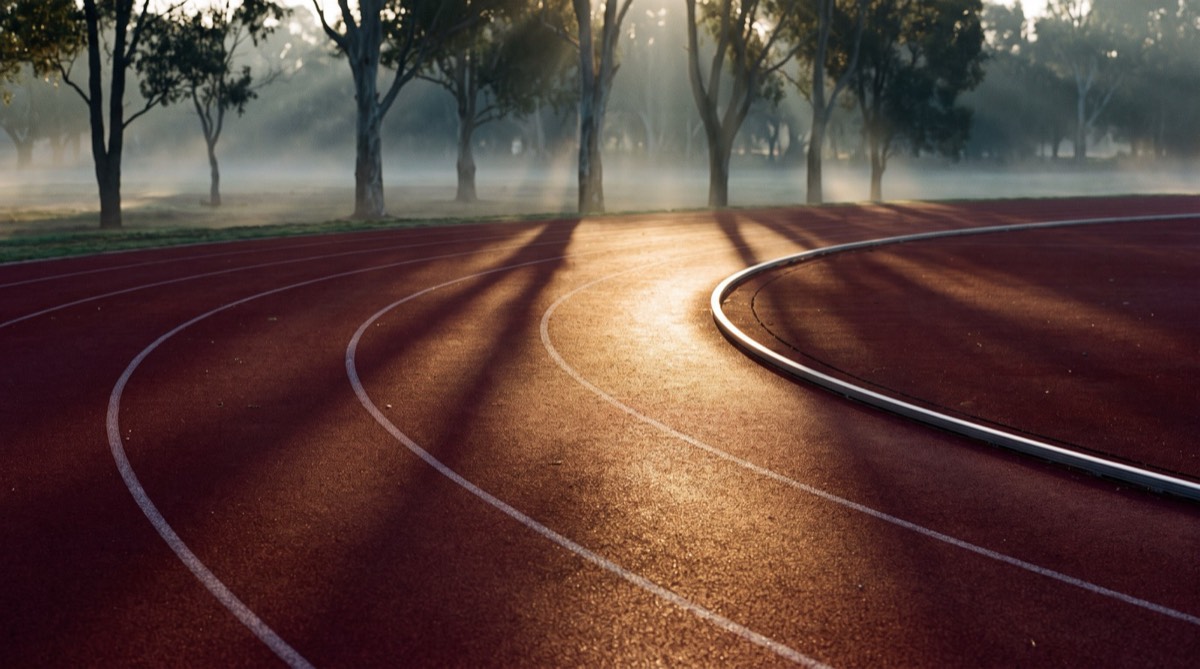 An empty running track at sunrise (illustrative image)