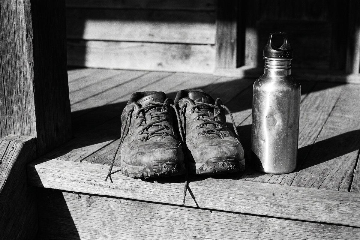 Walking shoes and a water bottle on a verandah step