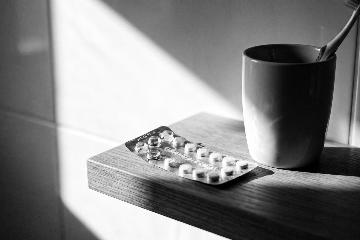 A blister pack of tablets on a bathroom shelf
